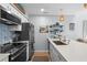 Bright kitchen featuring white cabinets, stainless steel appliances, and a stylish backsplash at 4470 Little River Inn Ln. # 1005, Little River, SC 29566