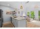 Open-concept kitchen with island, modern appliances, and seamless flow to the living area with a beautiful view at 4470 Little River Inn Ln. # 1005, Little River, SC 29566