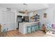 Kitchen with island, white cabinetry, modern appliances, and bar stool seating, open to the living space at 4470 Little River Inn Ln. # 1005, Little River, SC 29566
