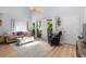 Comfortable living room with neutral tones, a plush sofa, and a view of the outdoor greenery at 4470 Little River Inn Ln. # 1005, Little River, SC 29566