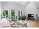 Bright living room featuring a high ceiling, comfortable seating, and access to a private balcony at 4470 Little River Inn Ln. # 1005, Little River, SC 29566