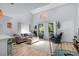 Bright and airy living room featuring a high ceiling, neutral decor, and access to an outdoor balcony at 4470 Little River Inn Ln. # 1005, Little River, SC 29566