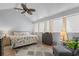 Bright and airy main bedroom with large windows, ceiling fan and comfortable seating area at 4470 Little River Inn Ln. # 1005, Little River, SC 29566