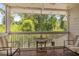 Charming screened-in patio with tile floors, ceiling fan, outdoor seating and wooded view at 4470 Little River Inn Ln. # 1005, Little River, SC 29566