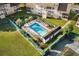Aerial view of a community pool, tennis courts, and well-manicured green spaces at 4470 Little River Inn Ln. # 1005, Little River, SC 29566