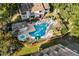 Aerial view of community pool with hot tub, lounge chairs, and green umbrellas at 4470 Little River Inn Ln. # 1005, Little River, SC 29566