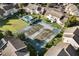 Aerial view of a community with tennis courts, a pool, and mature landscaping at 4470 Little River Inn Ln. # 1005, Little River, SC 29566