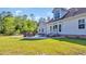 A backyard features a lush green lawn, patio area with outdoor furniture, and rear exterior of the house at 4524 Ramsey Ford Rd., Tabor City, NC 28463