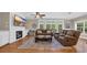 Comfortable living room featuring a fireplace, ceiling fan, hardwood floors, and a view to the outside at 4524 Ramsey Ford Rd., Tabor City, NC 28463
