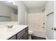 A bathroom with gray vanity, white shower/tub, and gray wood-look flooring at 469 Overcrest St., Myrtle Beach, SC 29579