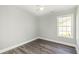 A neutral bedroom features gray floors, light walls, and lots of sunlight at 469 Overcrest St., Myrtle Beach, SC 29579