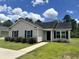 Charming single-story home with manicured lawn, black shutters, and a paved walkway at 469 Overcrest St., Myrtle Beach, SC 29579