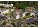 Aerial view of condo building near a pool, surrounded by parking and manicured landscaping at 4749 Wild Iris Dr. # 205, Myrtle Beach, SC 29577