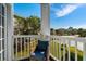 Cozy balcony chair overlooking grassy lawn in this condominium complex at 4749 Wild Iris Dr. # 205, Myrtle Beach, SC 29577