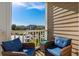 Comfortable chairs on the balcony provide a relaxing spot overlooking the parking at 4749 Wild Iris Dr. # 205, Myrtle Beach, SC 29577