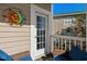 Balcony with seating and decorative sun art looking out onto the brick apartment complex at 4749 Wild Iris Dr. # 205, Myrtle Beach, SC 29577