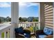 A cozy balcony with chairs offers views of the landscaped grounds at 4749 Wild Iris Dr. # 205, Myrtle Beach, SC 29577