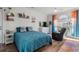 Bedroom features a queen bed, a leather recliner, hardwood floors, and colorful curtains and accessories at 4749 Wild Iris Dr. # 205, Myrtle Beach, SC 29577
