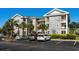 Attractive condo building with stone and siding, multiple balconies, and well maintained landscaping at 4749 Wild Iris Dr. # 205, Myrtle Beach, SC 29577