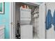 Efficient laundry area with stacked washer/dryer and shelving for storage and organization at 4749 Wild Iris Dr. # 205, Myrtle Beach, SC 29577