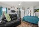 Studio living room showcases hardwood floors, a loveseat, modern kitchen appliances, and an ensuite bathroom at 4749 Wild Iris Dr. # 205, Myrtle Beach, SC 29577