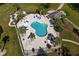 Aerial view of a kidney shaped pool with lounge chairs and nearby cabana in a landscaped community at 4749 Wild Iris Dr. # 205, Myrtle Beach, SC 29577