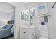 The bathroom features a well-lit vanity, plus a glimpse into the bedroom, creating a seamless and stylish transition at 4803 Bovardia Pl. # 104, Myrtle Beach, SC 29577