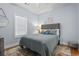 Comfortable bedroom features a luxurious gray quilted bedspread, accent pillows, and a stylish decorative rug at 4803 Bovardia Pl. # 104, Myrtle Beach, SC 29577
