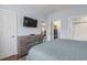 This bedroom includes a dresser with TV, a closet, and access to a well-equipped bathroom at 4803 Bovardia Pl. # 104, Myrtle Beach, SC 29577