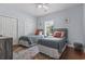 Bright bedroom features twin beds, hardwood floors, and ample closet space at 4803 Bovardia Pl. # 104, Myrtle Beach, SC 29577