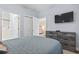 Bright bedroom with TV, closet, and bathroom, offering ample space and convenience at 4803 Bovardia Pl. # 104, Myrtle Beach, SC 29577