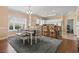 Dining area with stylish table, bench seating, and adjacent kitchen bar at 4803 Bovardia Pl. # 104, Myrtle Beach, SC 29577