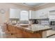 Modern kitchen design featuring granite countertops, white cabinets, and sleek stainless steel appliances at 4803 Bovardia Pl. # 104, Myrtle Beach, SC 29577