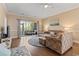 Bright living room with hardwood floors and sliding glass doors to outdoor patio at 4803 Bovardia Pl. # 104, Myrtle Beach, SC 29577