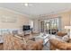 Cozy living room with hardwood floors, plush furniture, and access to an outdoor patio at 4803 Bovardia Pl. # 104, Myrtle Beach, SC 29577