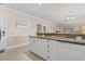 Open-concept living space features a kitchen with granite countertops, and seamlessly connects to the living and dining areas at 4803 Bovardia Pl. # 104, Myrtle Beach, SC 29577