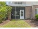 Charming outdoor patio with brick accents and access to a serene garden, perfect for relaxation and privacy at 4803 Bovardia Pl. # 104, Myrtle Beach, SC 29577