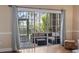 Inviting sun room with wicker furniture, decorative rug, and large windows providing ample natural light and serene views at 4803 Bovardia Pl. # 104, Myrtle Beach, SC 29577