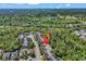 Scenic aerial view of a neighborhood surrounded by lush greenery and a glimpse of the distant ocean at 4814 Greenhaven Dr., North Myrtle Beach, SC 29582