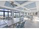 Elegant clubhouse with a view of the beach featuring modern tables and chairs and large glass doors at 4814 Greenhaven Dr., North Myrtle Beach, SC 29582