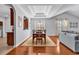 Open dining area with elegant tray ceiling, hardwood floors, and open flow to living spaces at 4814 Greenhaven Dr., North Myrtle Beach, SC 29582