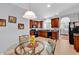 Eat-in kitchen displays glass table, rich cabinets, and black appliances at 4814 Greenhaven Dr., North Myrtle Beach, SC 29582