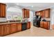 Kitchen offers tile floors, wooden cabinets, with granite counters and black appliances at 4814 Greenhaven Dr., North Myrtle Beach, SC 29582