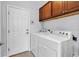 Laundry room equipped with washer, dryer, and storage cabinets at 4814 Greenhaven Dr., North Myrtle Beach, SC 29582