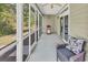 Screened-in patio with seating, ceiling fan and a red grill at 4814 Greenhaven Dr., North Myrtle Beach, SC 29582