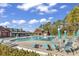 Resort-style community pool area with plenty of seating, umbrellas, and a clubhouse in the background at 4814 Greenhaven Dr., North Myrtle Beach, SC 29582