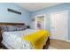 Calming bedroom with soft blue walls, wooden bed and doorway view at 4847 Carnation Circle # 201, Myrtle Beach, SC 29577