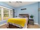 Cozy bedroom with a wooden bed frame, soft carpet, and sunny window view at 4847 Carnation Circle # 201, Myrtle Beach, SC 29577