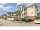 Charming condo complex with garages, stairs to unit entrances, brick accents, and accessible parking at 4847 Carnation Circle # 201, Myrtle Beach, SC 29577