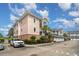 Condo complex showing garages, stairs to unit entrances, professional landscaping, and well maintained parking area at 4847 Carnation Circle # 201, Myrtle Beach, SC 29577